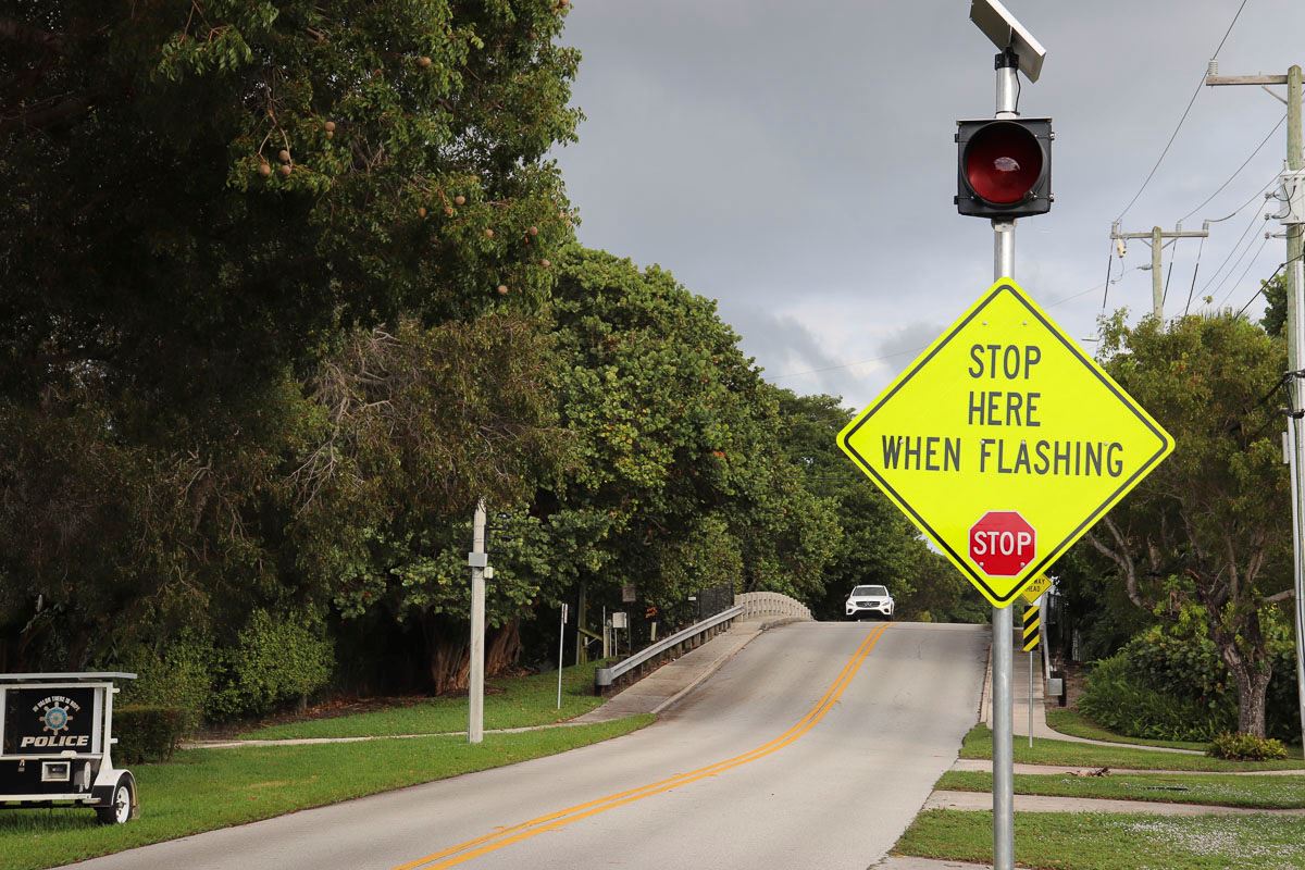 Image of electronic stop sign with bridge in background