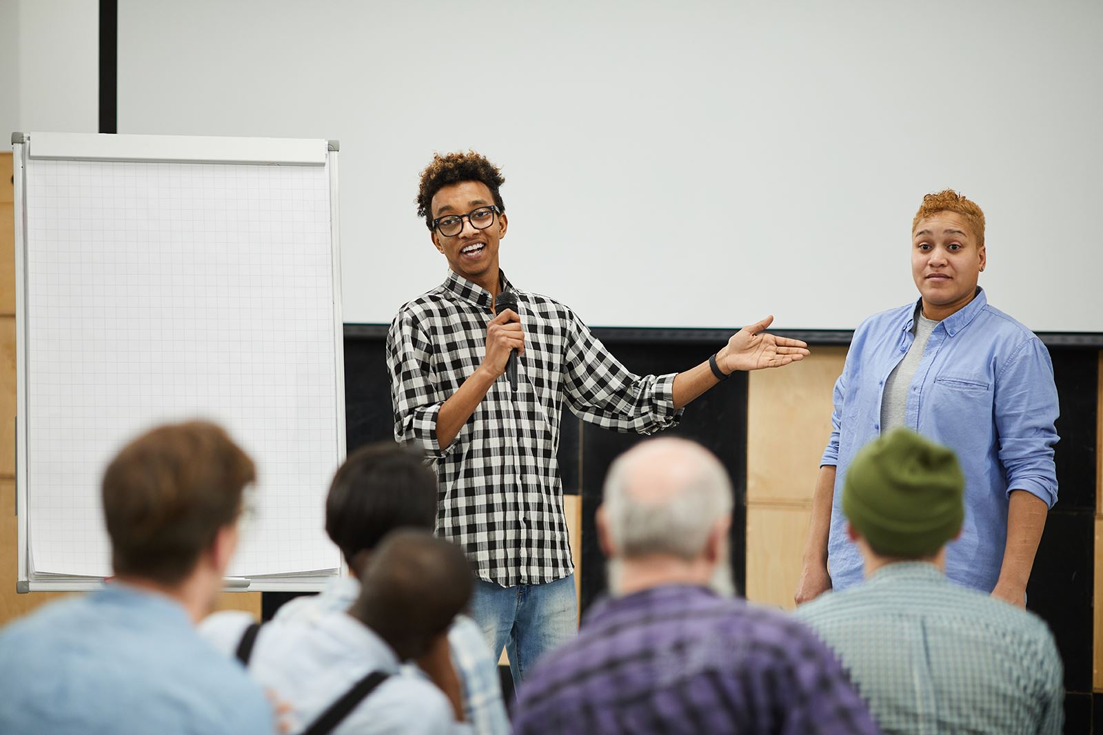 young male speaker-talking-to-audience-at-conference