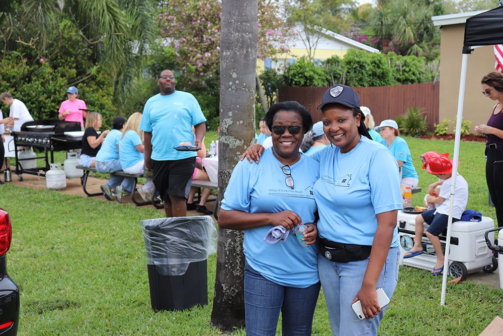 Photos of volunteers painting houses at NET event